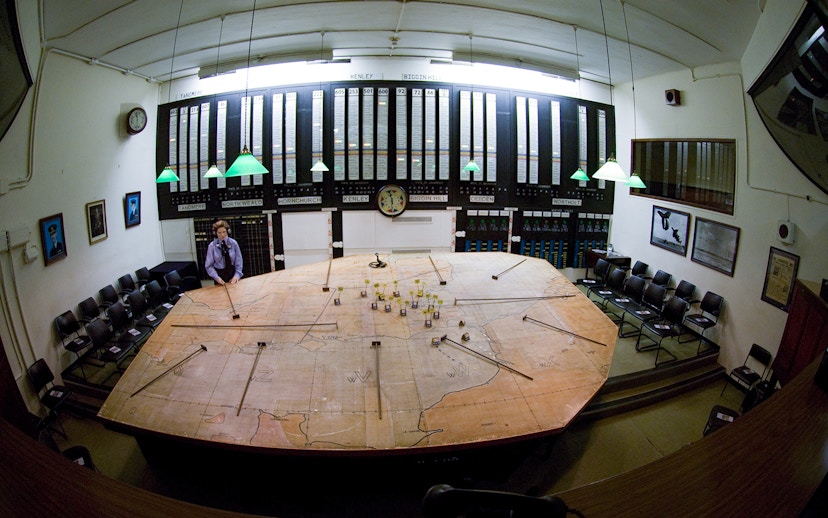 War room map table at Churchill's War Rooms, London, with historical displays and seating.