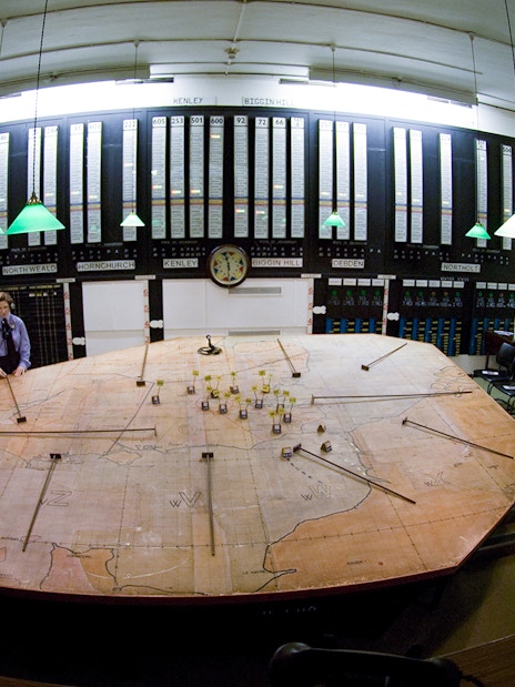 War room map table at Churchill's War Rooms, London, with historical displays and seating.