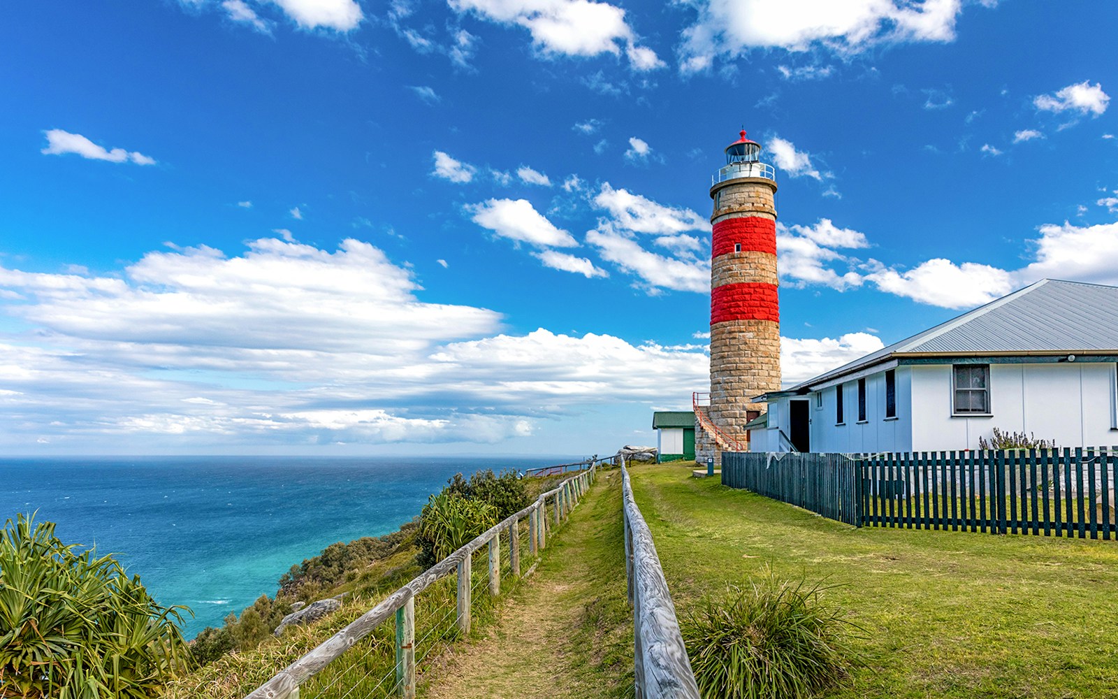 Moreton Island lighthouse with ocean view in the background.