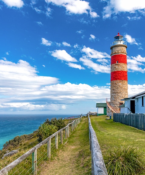 Moreton Island lighthouse with ocean view in the background.