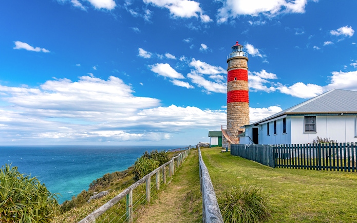 Moreton Island lighthouse with ocean view in the background.
