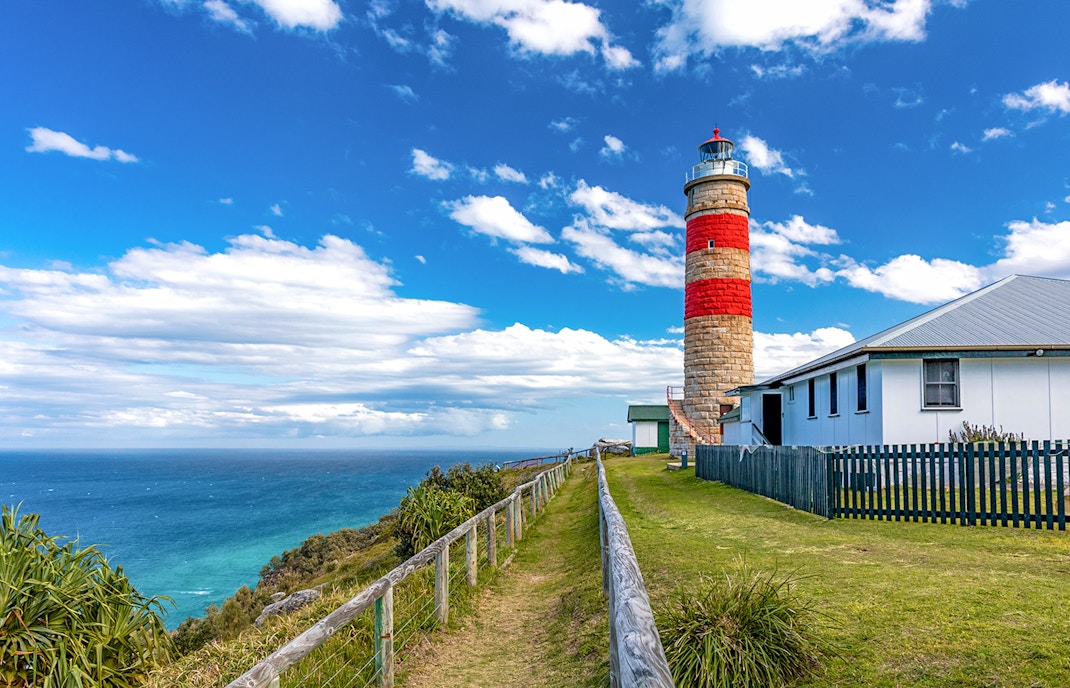 Moreton Island lighthouse with ocean view in the background.