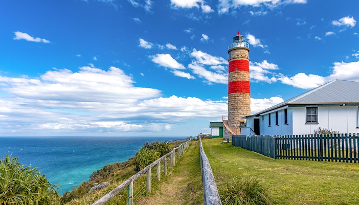 Moreton Island lighthouse with ocean view in the background.