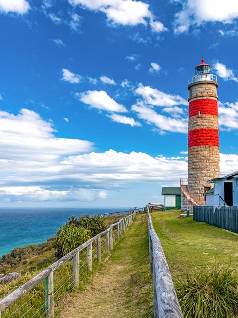Moreton Island lighthouse with ocean view in the background.