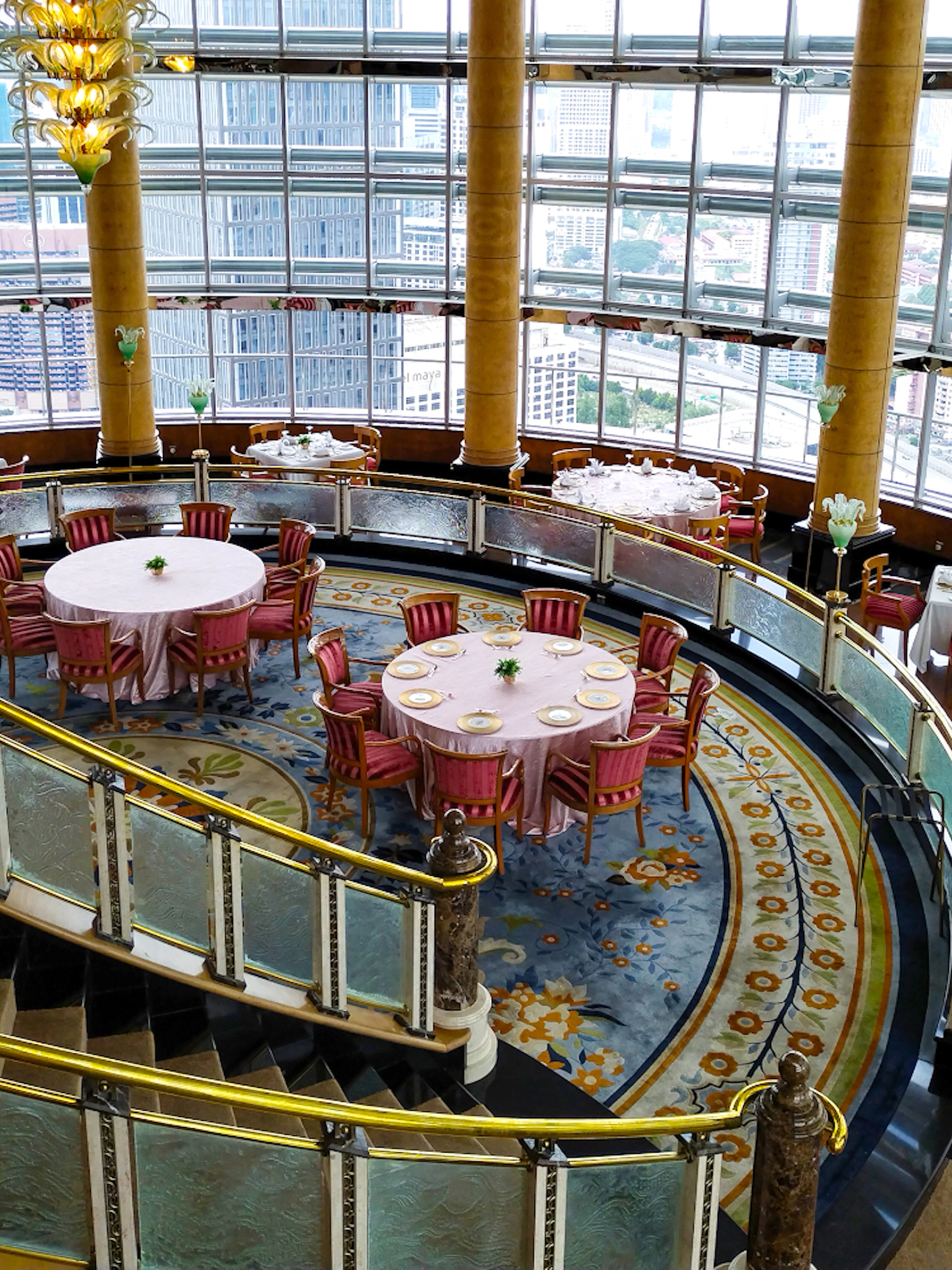 Dining area at KLCC@42 restaurant in Petronas Twin Towers with city view.