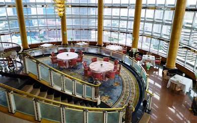 Dining area at KLCC@42 restaurant in Petronas Twin Towers with city view.