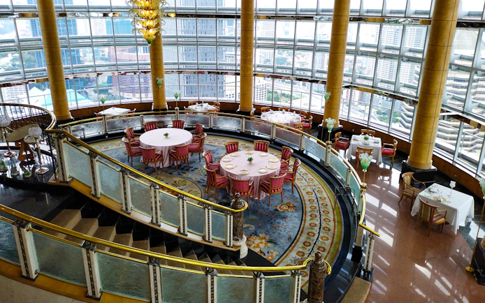 Dining area at KLCC@42 restaurant in Petronas Twin Towers with city view.