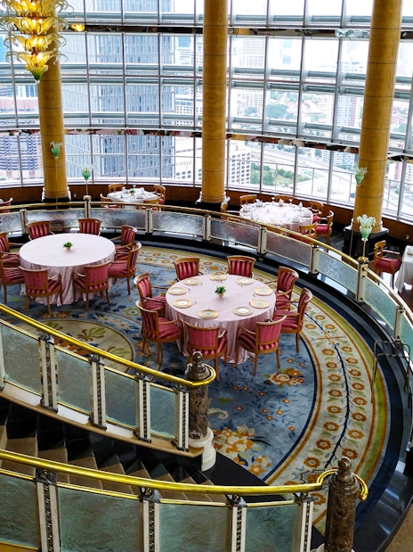 Dining area at KLCC@42 restaurant in Petronas Twin Towers with city view.