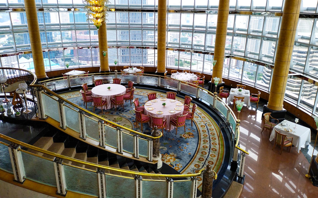 Dining area at KLCC@42 restaurant in Petronas Twin Towers with city view.