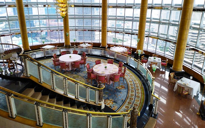 Dining area at KLCC@42 restaurant in Petronas Twin Towers with city view.