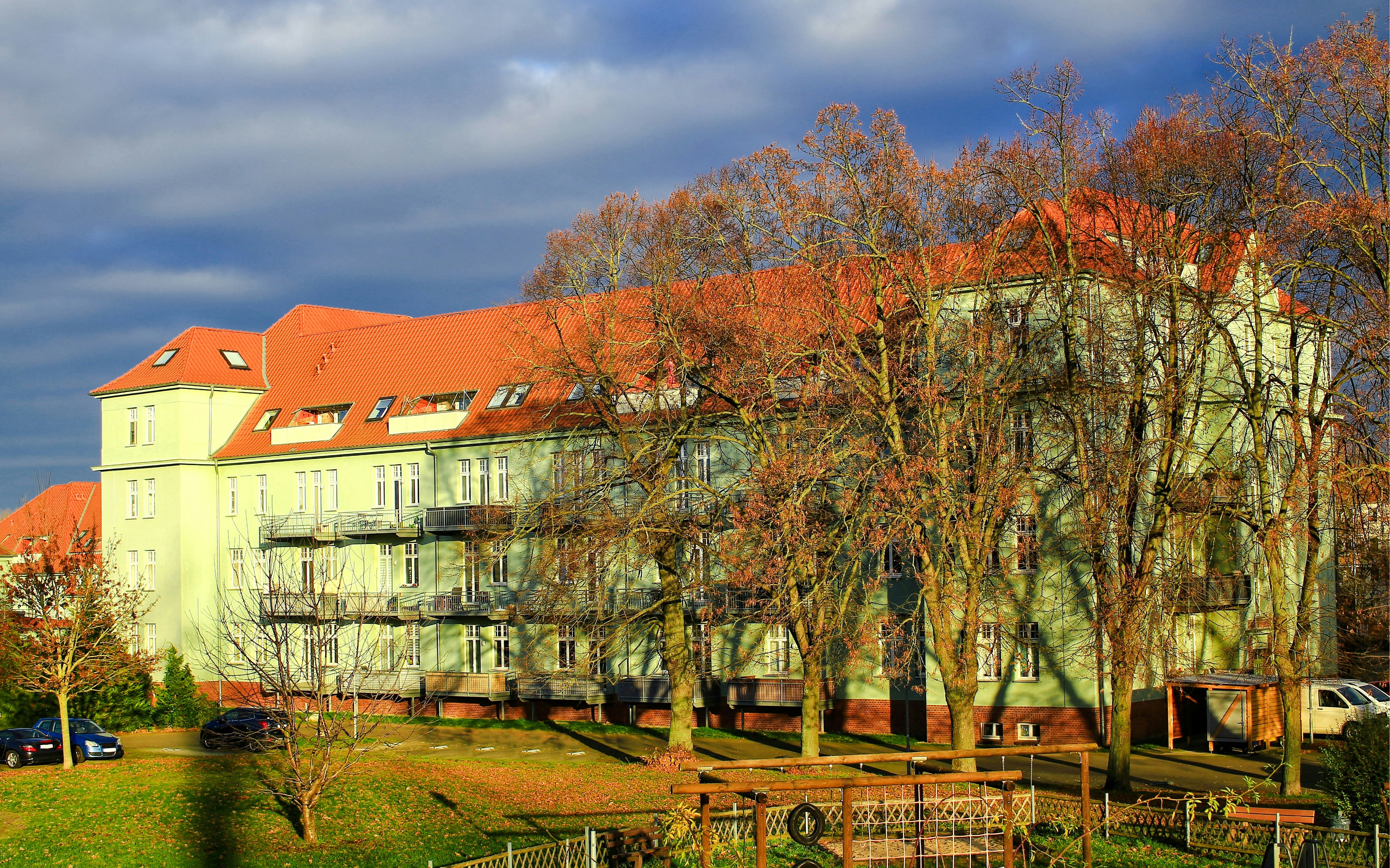 Magdeburg Barracks building with red roof and surrounding trees in autumn.