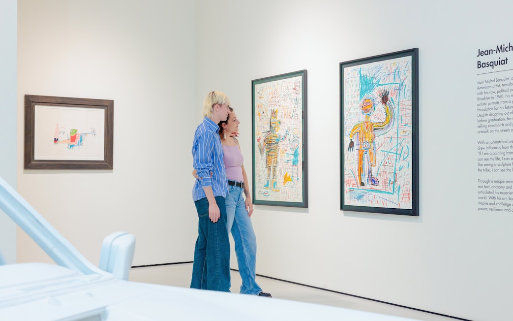 Guests viewing Basquiat artwork at Moco Museum London exhibit.