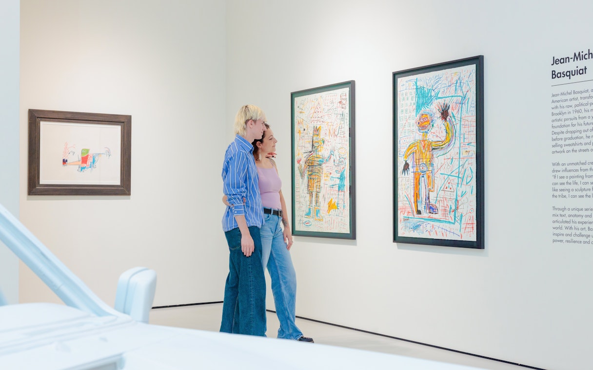 Guests viewing Basquiat artwork at Moco Museum London exhibit.