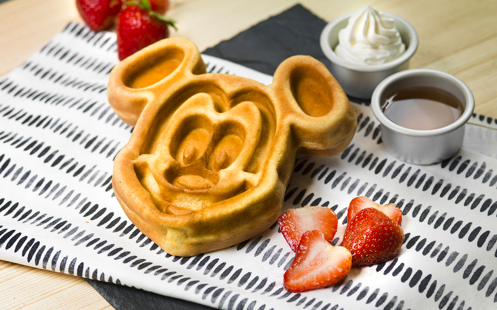 Mickey Mouse waffle with strawberries and syrup at Disneyland Hong Kong.