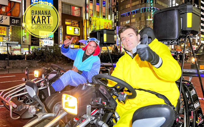 Go-kart riders in costumes on Tokyo street during Banana Kart tour from Shinjuku to Shibuya.