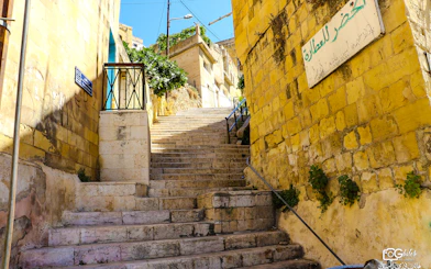 Stone staircase in As-Salt, Jordan, leading through historic buildings on the Harmony Trail.