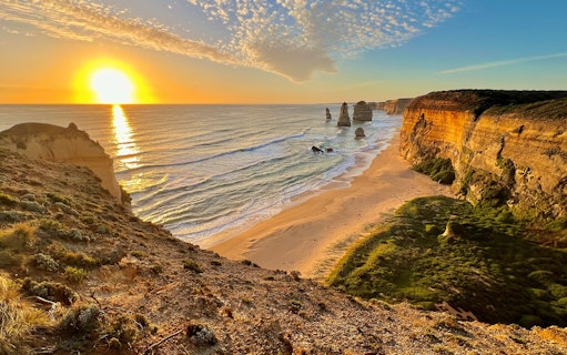 Great Ocean Road sunset with Twelve Apostles rock formations in view.