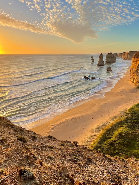 Great Ocean Road sunset with Twelve Apostles rock formations in view.