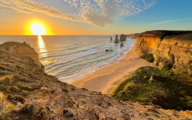 Great Ocean Road sunset with Twelve Apostles rock formations in view.
