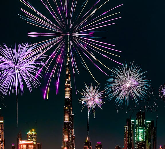 Dubai skyline with fireworks over Burj Khalifa on New Year's Eve.