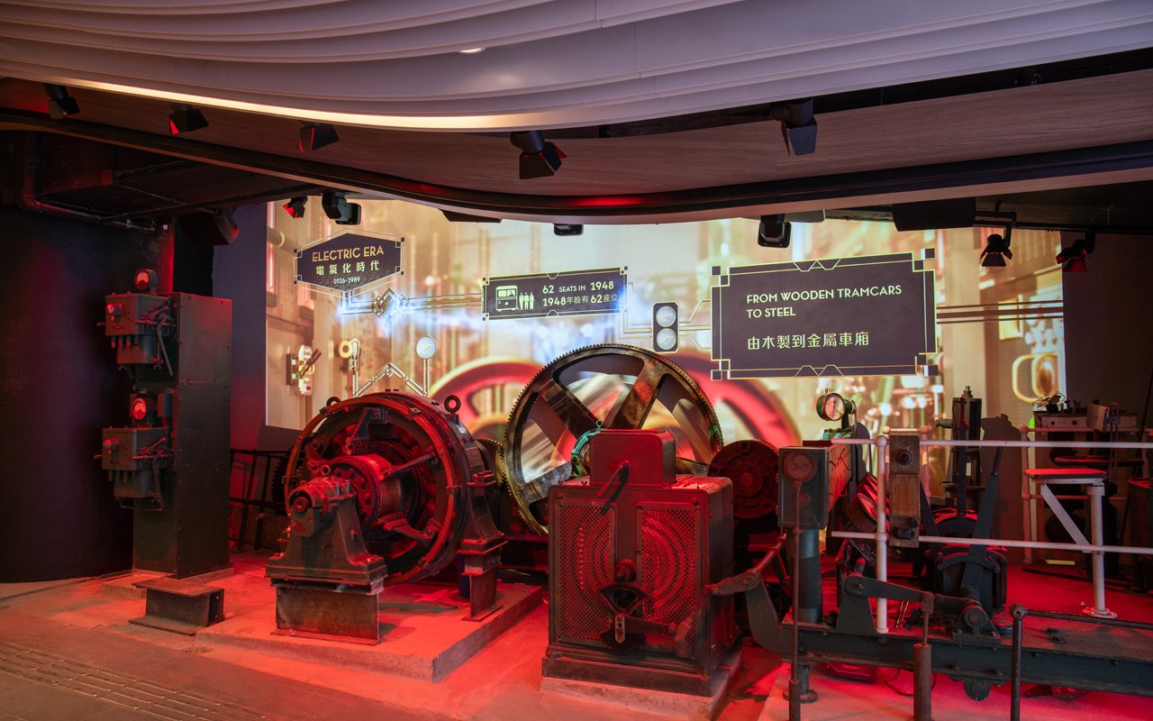 Historic machinery display at The Peak Tram exhibition in Hong Kong, showcasing tram evolution.