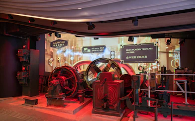 Historic machinery display at The Peak Tram exhibition in Hong Kong, showcasing tram evolution.