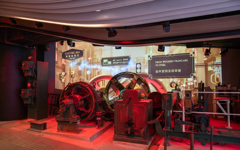 Historic machinery display at The Peak Tram exhibition in Hong Kong, showcasing tram evolution.