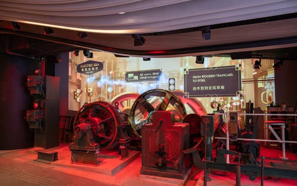 Historic machinery display at The Peak Tram exhibition in Hong Kong, showcasing tram evolution.