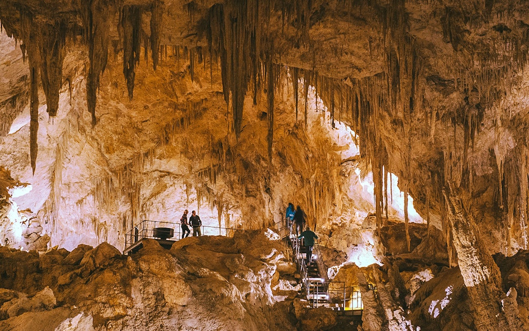Visitors exploring stalactites in Mammoth Cave, Margaret River on a self-guided audio tour.