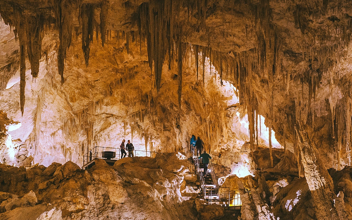 Visitors exploring stalactites in Mammoth Cave, Margaret River on a self-guided audio tour.