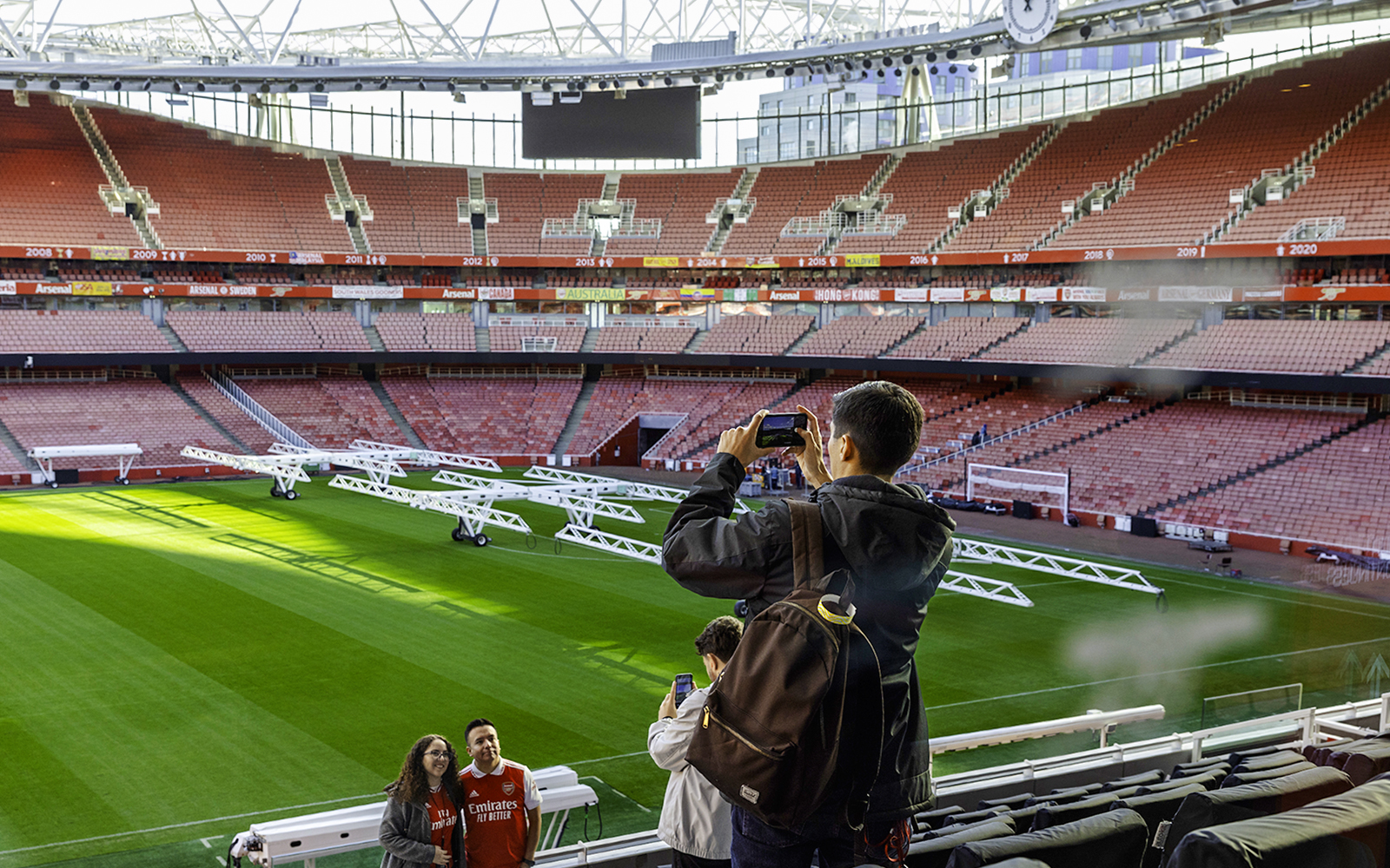 Visitors taking photos inside Emirates Stadium, London.