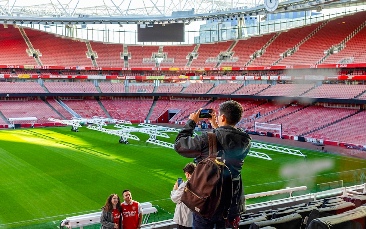 Visitors taking photos inside Emirates Stadium, London.