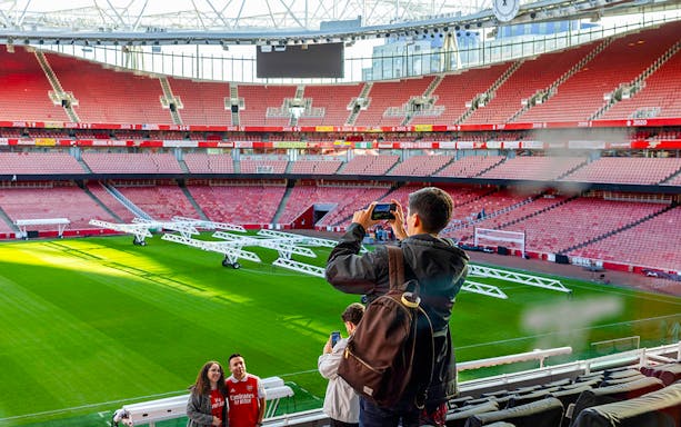 Visitors taking photos inside Emirates Stadium, London.