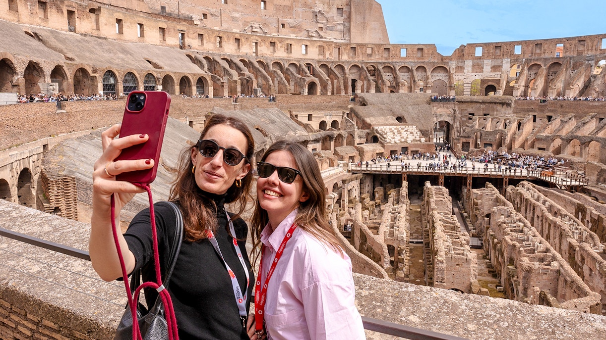Group of tourists enjoying a Colosseum Guided Tour in Rome, Italy, with a clear view of the ancient amphitheater