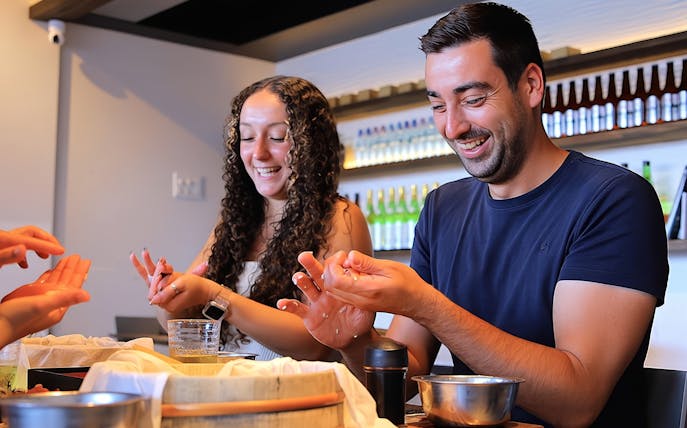 Couple enjoying sushi making class in Asakusa, Tokyo.