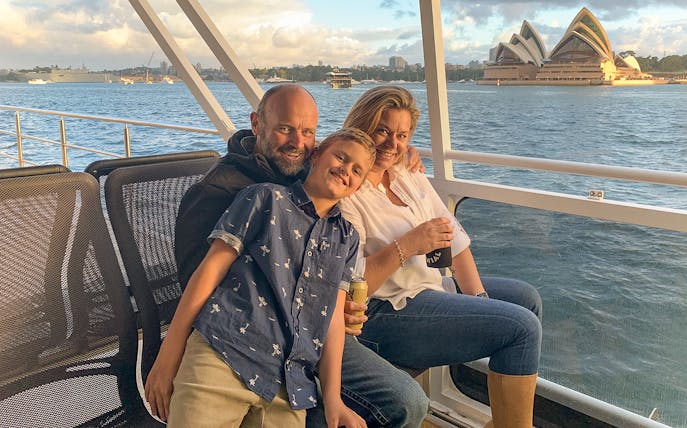 Family enjoying Sydney Harbour cruise with Opera House view.