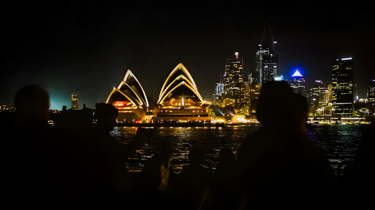 People viewing Sydney Opera House from a cruise during New Year's Eve at Sydney Harbour.