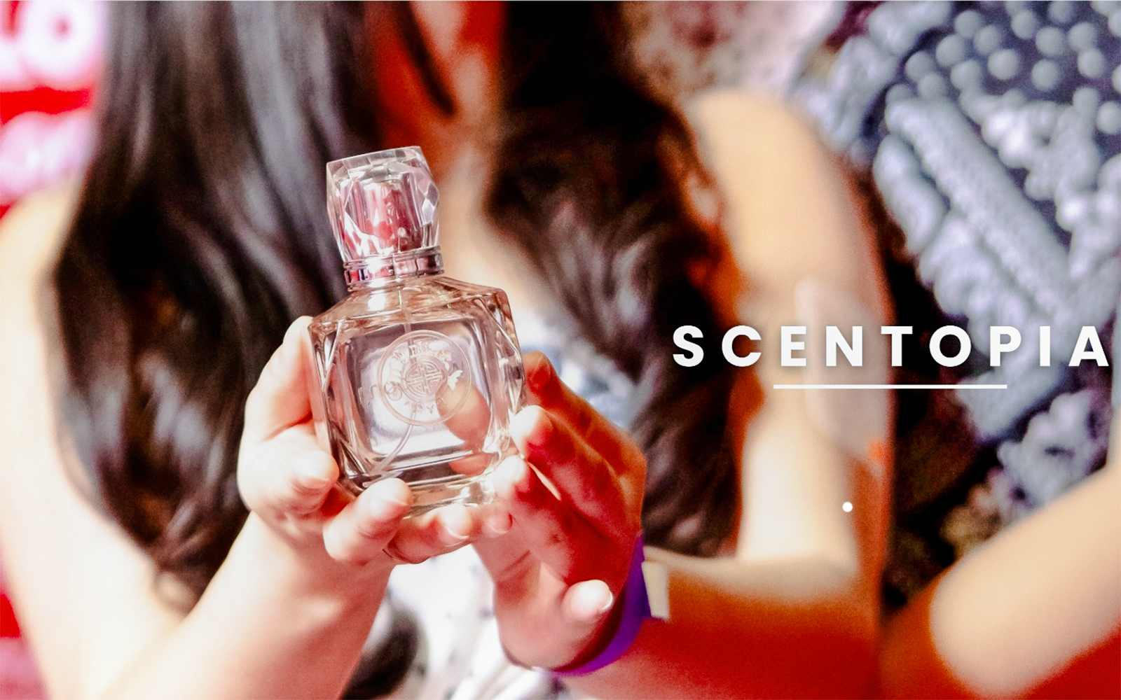 Tourist holding a perfume bottle at Scentopia Sentosa Singapore.