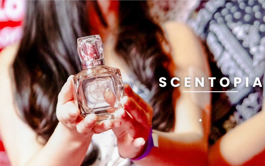 Tourist holding a perfume bottle at Scentopia Sentosa Singapore.