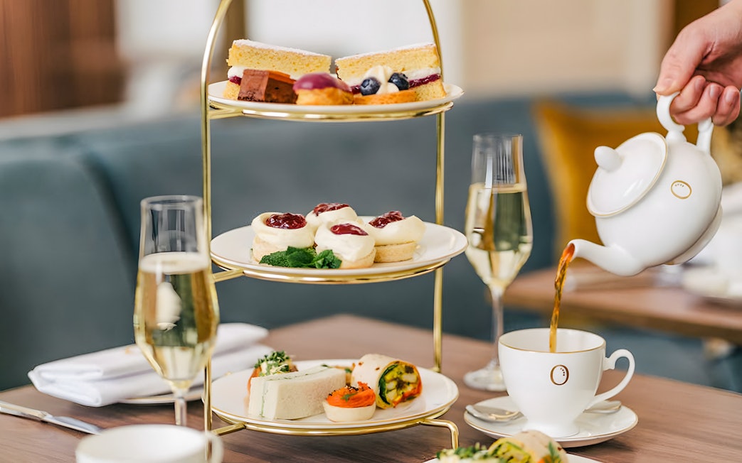 Afternoon tea set with pastries and sandwiches at Kensington Palace.