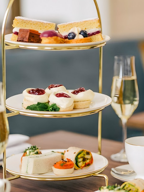 Afternoon tea set with pastries and sandwiches at Kensington Palace.
