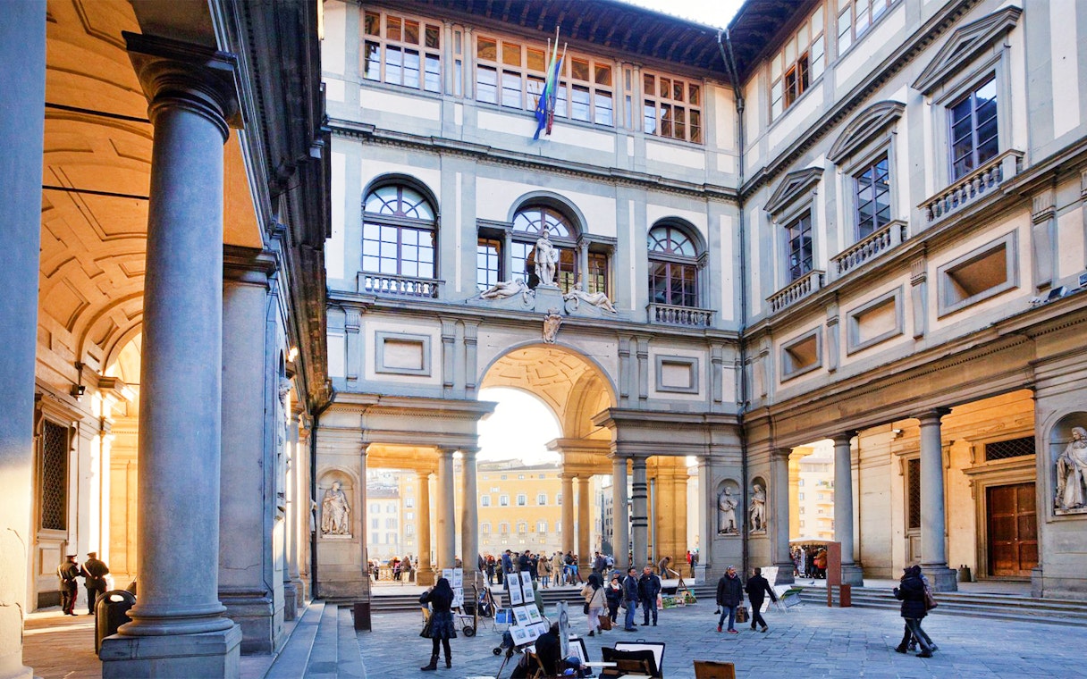 Uffizi Gallery courtyard with visitors in Florence, Italy.