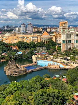 Aerial view of Sunway Lagoon theme park in Malaysia with water attractions and surrounding cityscape.