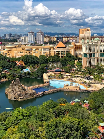 Aerial view of Sunway Lagoon theme park in Malaysia with water attractions and surrounding cityscape.