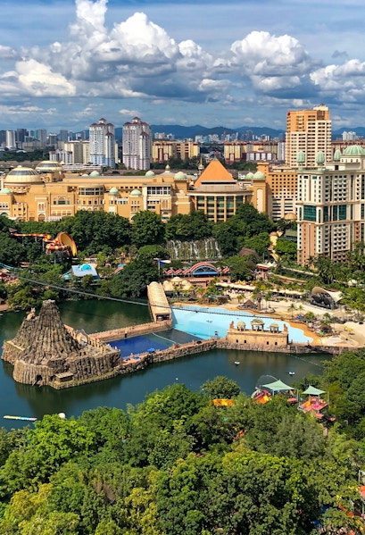 Aerial view of Sunway Lagoon theme park in Malaysia with water attractions and surrounding cityscape.