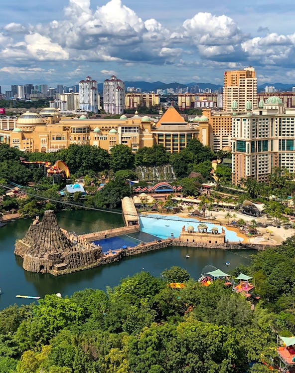 Aerial view of Sunway Lagoon theme park in Malaysia with water attractions and surrounding cityscape.