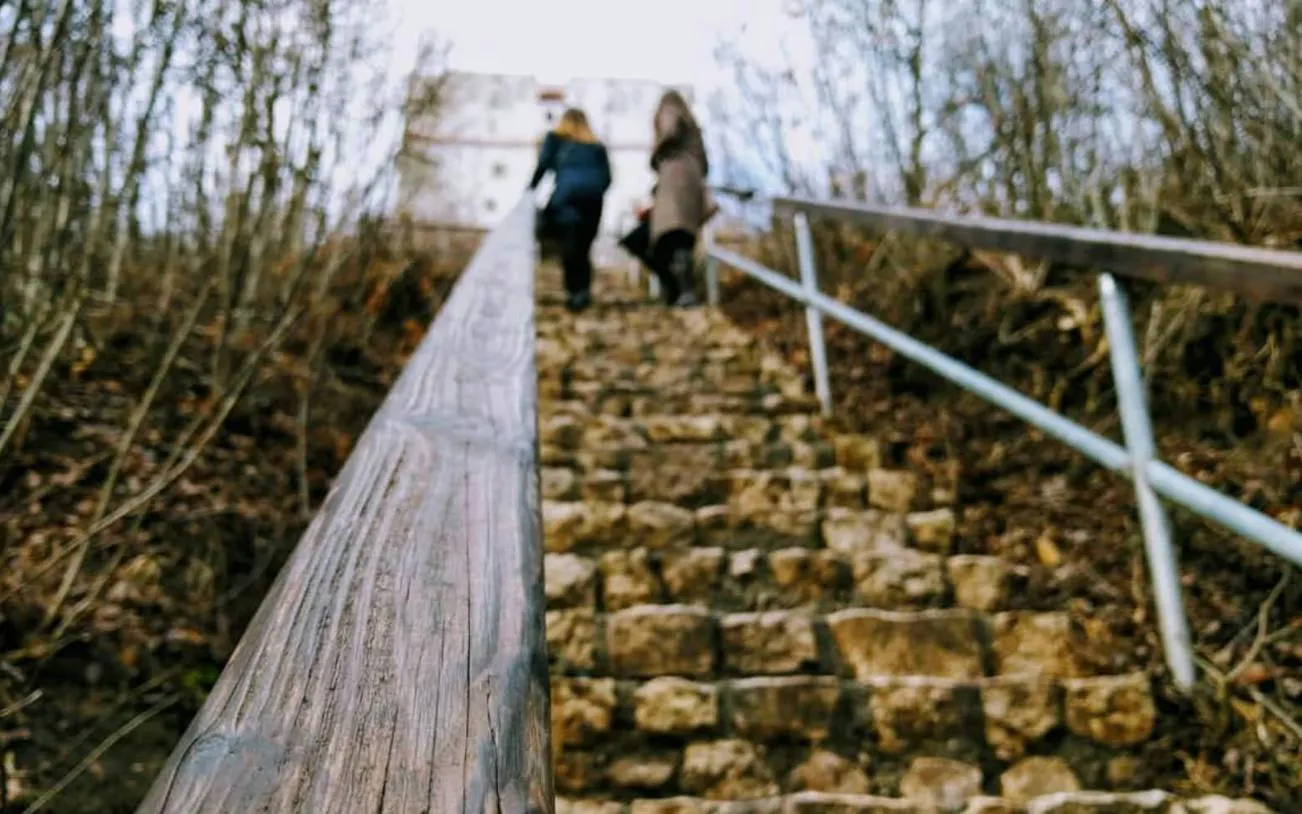 Stone steps leading to a historic building in Brasov, part of a self-guided city exploration game.