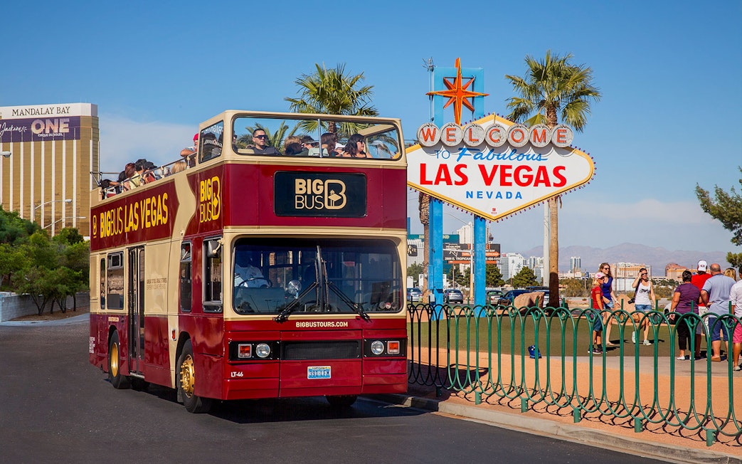 Las Vegas hop-on hop-off bus near Welcome to Fabulous Las Vegas sign.