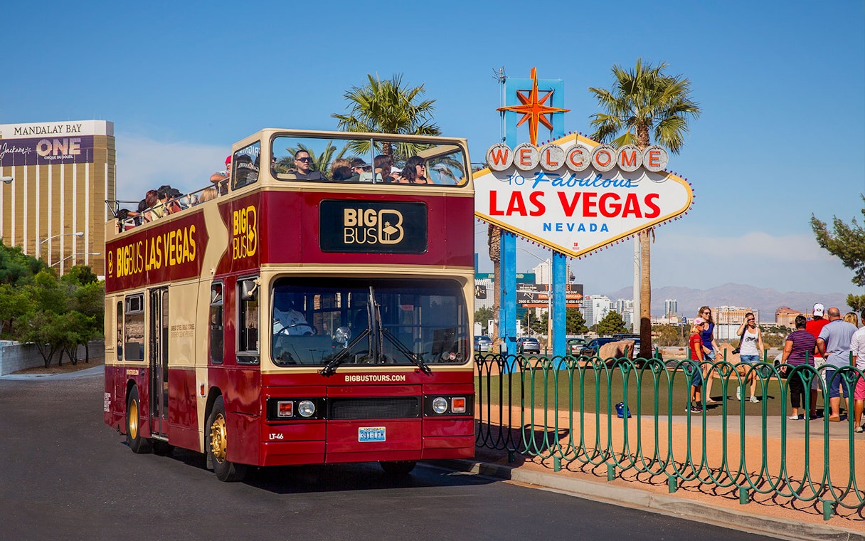 Las Vegas hop-on hop-off bus near Welcome to Fabulous Las Vegas sign.