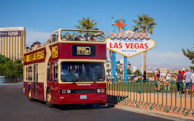 Las Vegas hop-on hop-off bus near Welcome to Fabulous Las Vegas sign.